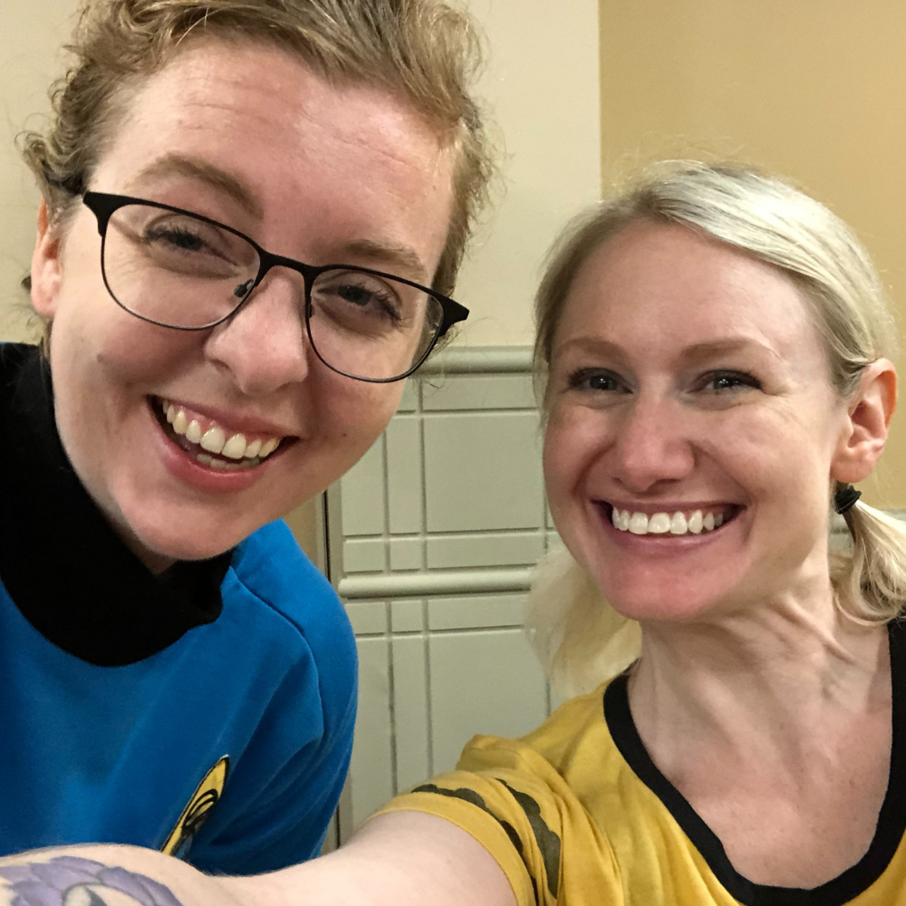 Larisa and Justine wear Star Trek uniforms and smile at the camera.